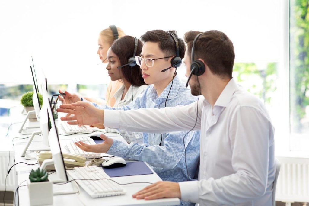 Call center employees working with headsets